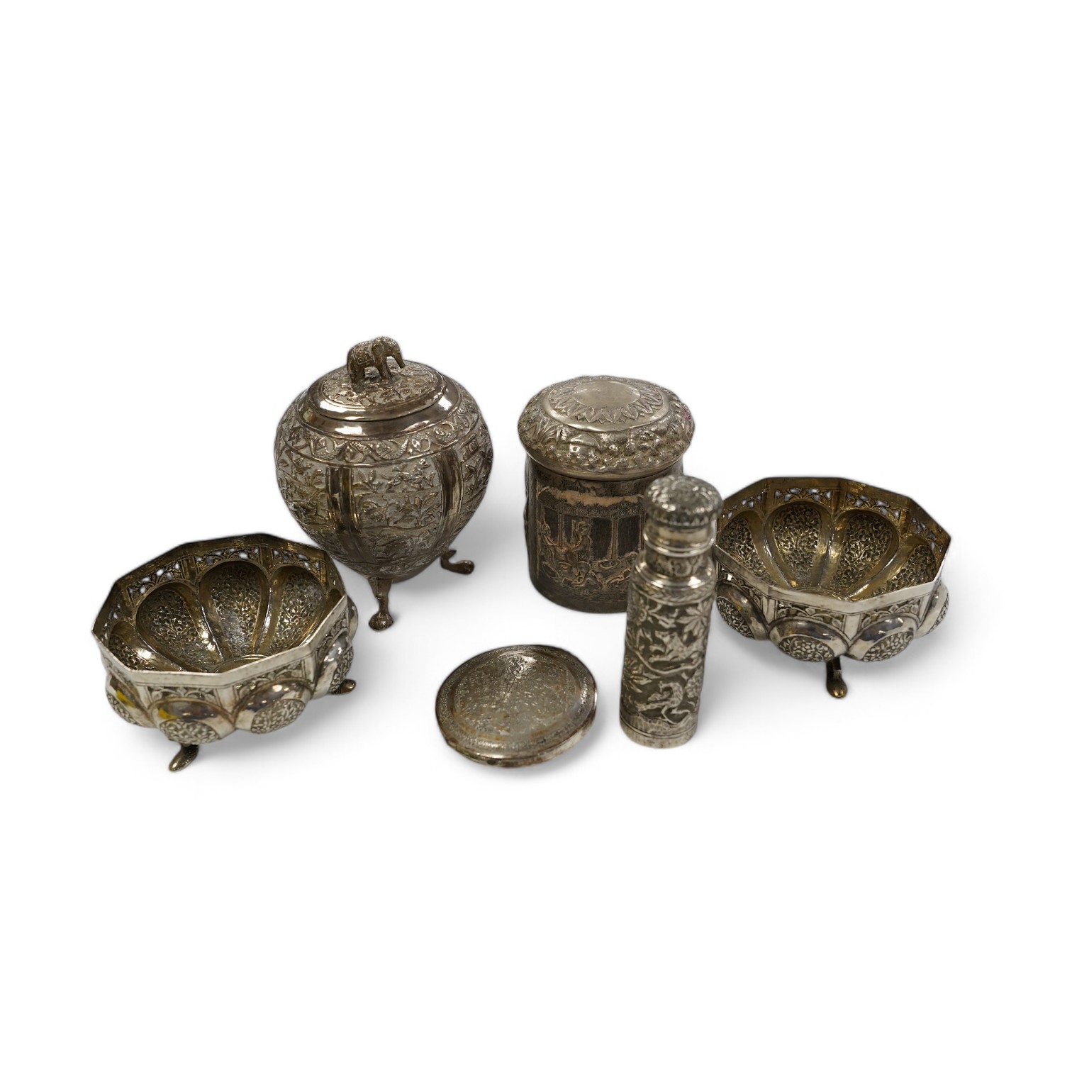 A pair of Indian pierced cusped white metal bowls, diameter 84mm, three other Indian white metal canisters and a Middle Eastern pill box. Condition - fair